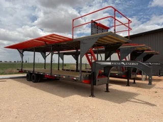 Two Flight Deck gooseneck trailers side by side, showing the raised decks and railings