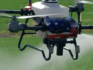 Revolution I-19 with an American flag wrap spraying over a green field