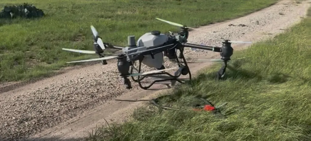 DJI Agras T50 spray drone parked at the edge of a ranch road